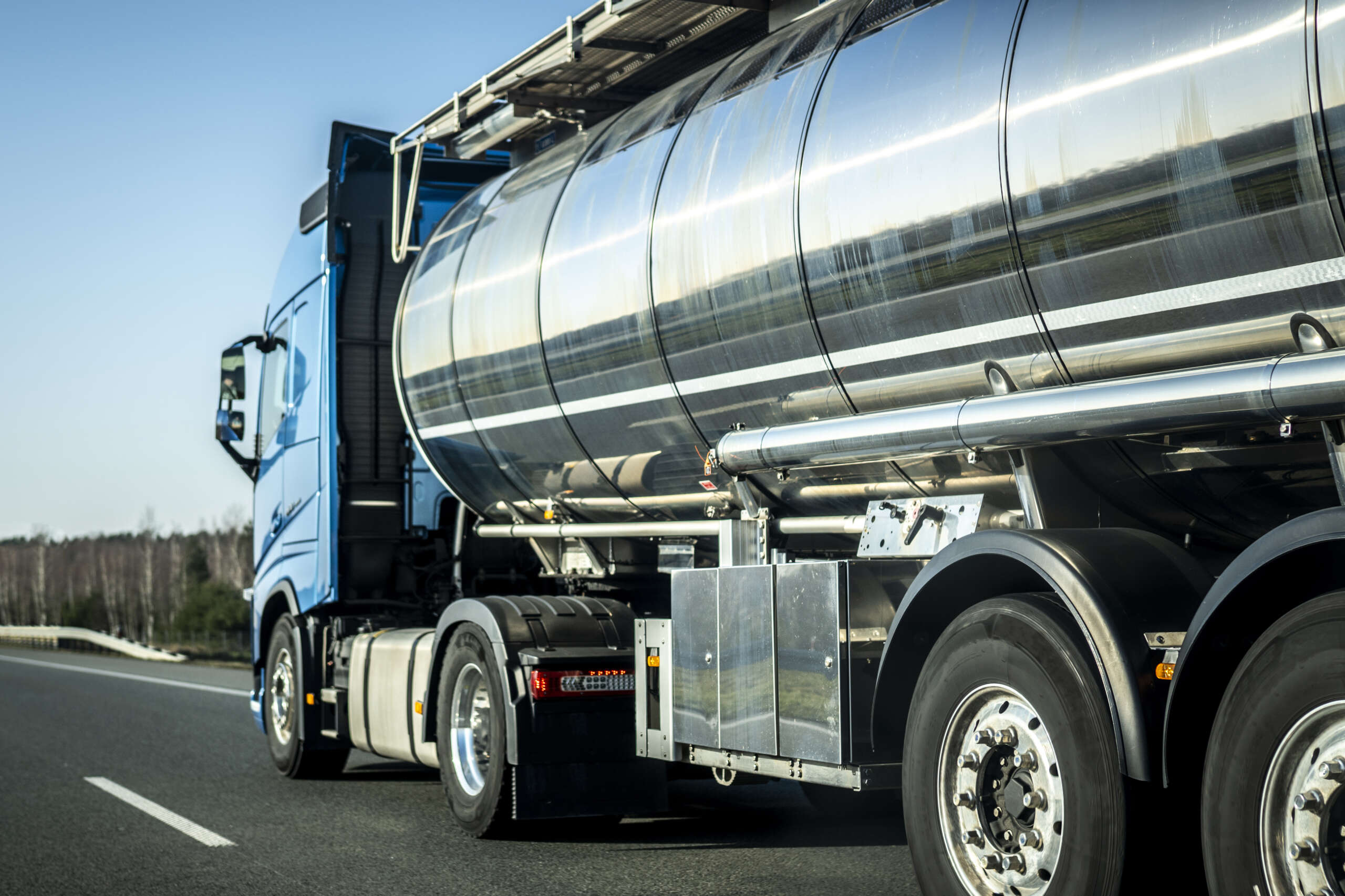 long vehicle truck with tank trailer on a highway.