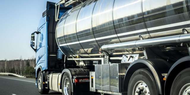 long vehicle truck with tank trailer on a highway.
